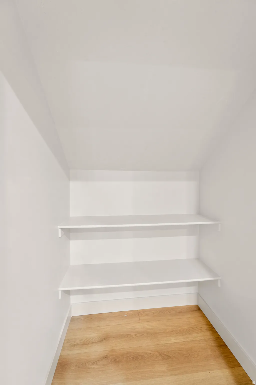 White painted walls with wood-finish flooring