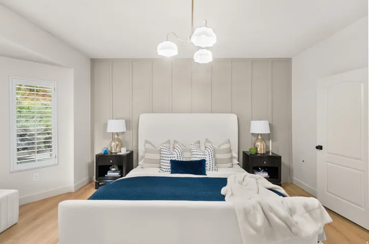 Light wood-finish flooring with a panel accent wall