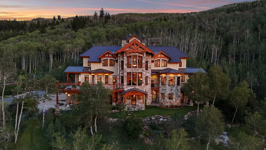 Stone and timber-frame exterior featuring multiple balconies and a dark metal roof