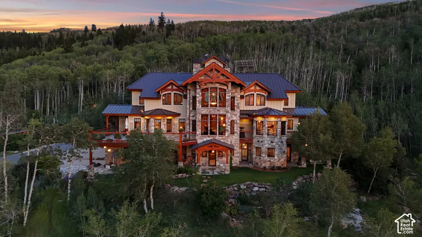 Stone and timber-frame exterior featuring multiple balconies and a dark metal roof