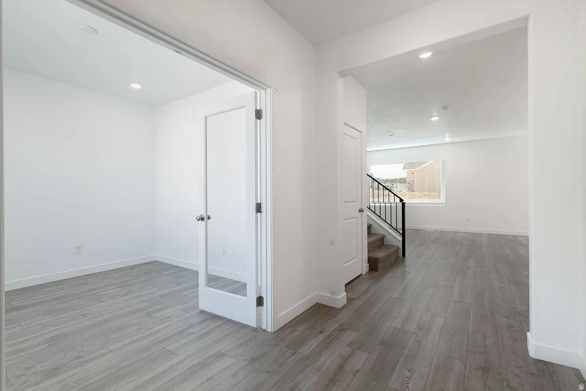 Hardwood-finish flooring throughout, recessed lighting, and a white interior paint scheme