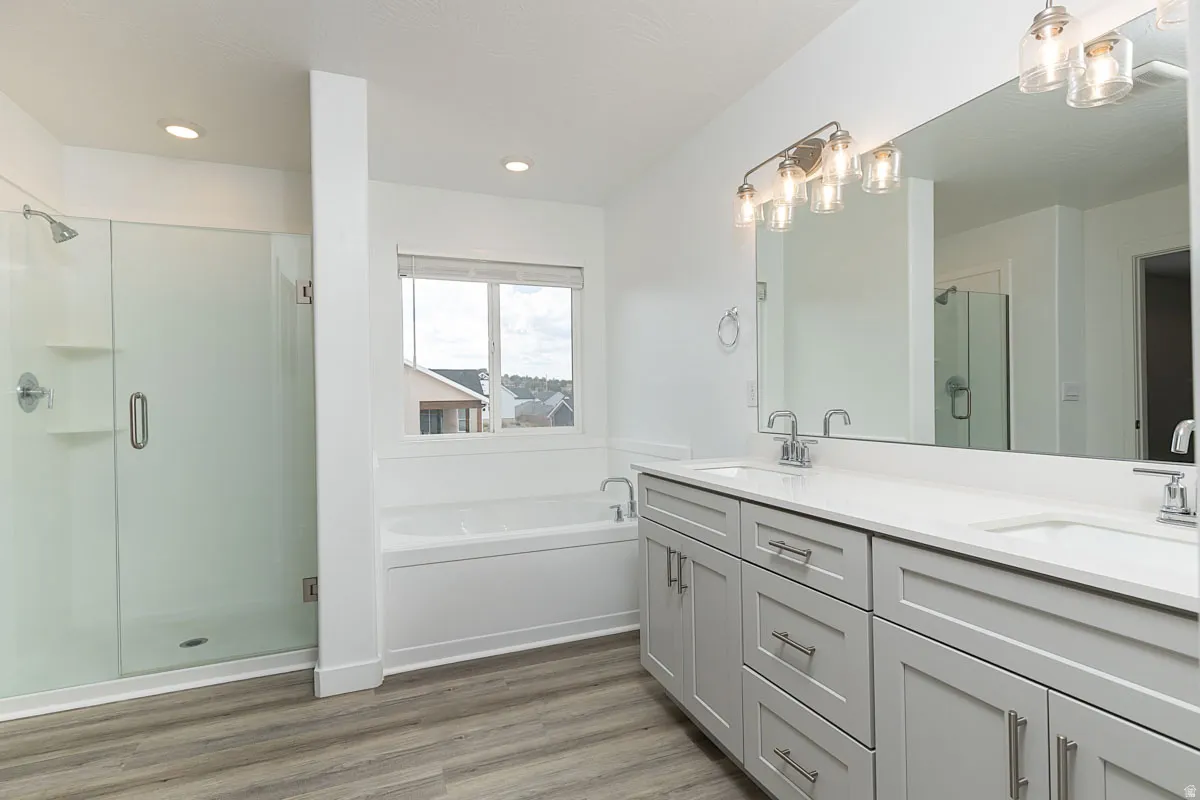 Double vanity with integrated sinks, framed mirror, and contemporary light fixture