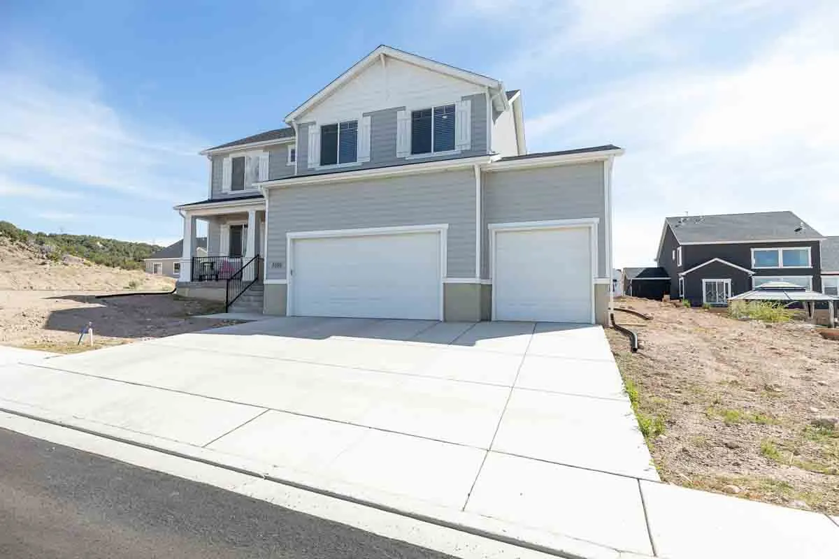 Two-story residence with light gray siding and white trim