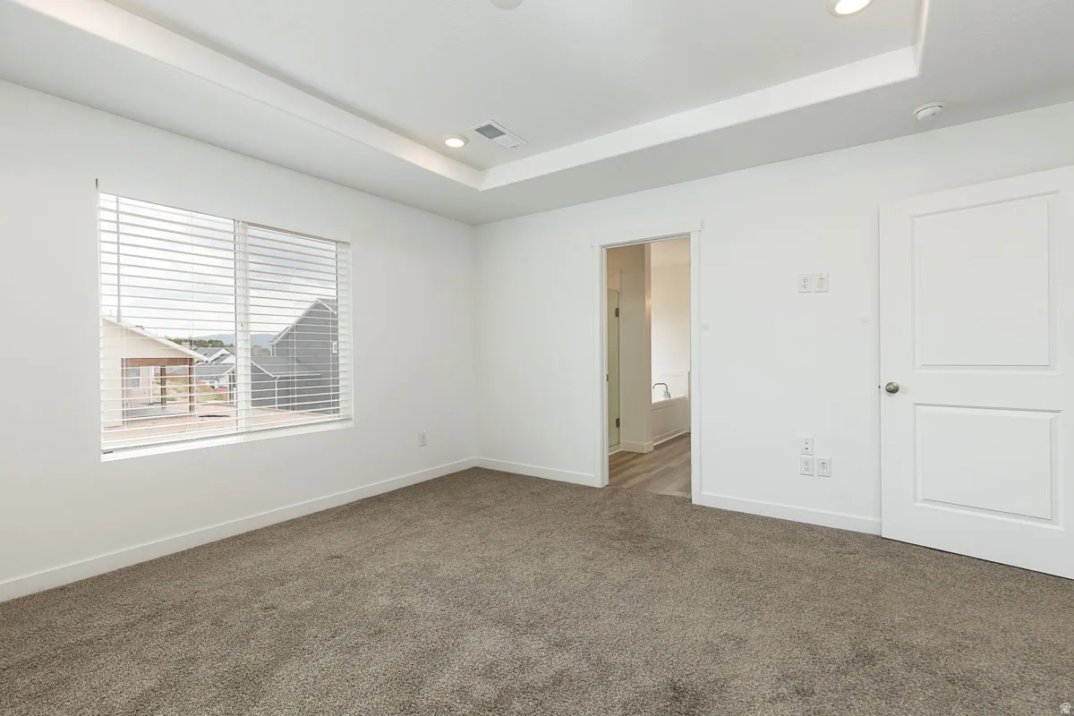 Recessed lighting illuminates a tray ceiling