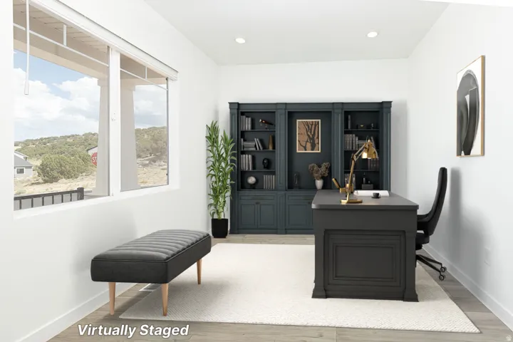 Spacious room featuring multiple windows, recessed lighting, and wood-finish flooring