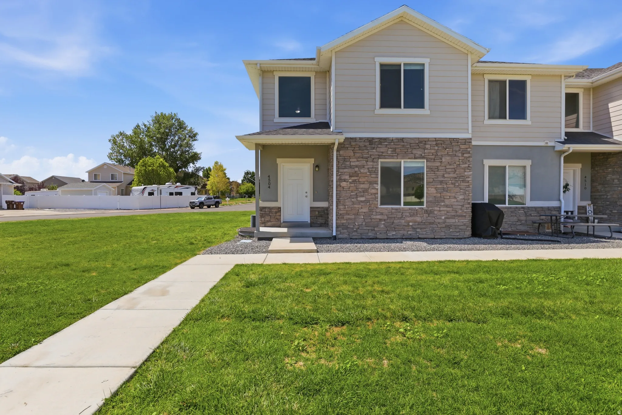 Two-story exterior featuring stone veneer and horizontal siding