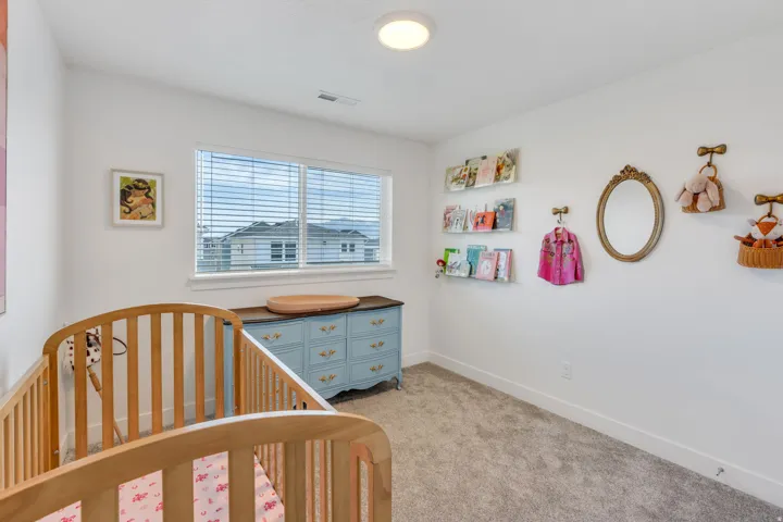 Window with horizontal blinds, overhead lighting, and wall-mounted shelving