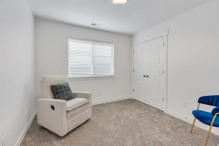 Light-toned carpeted flooring complements white painted walls and trim