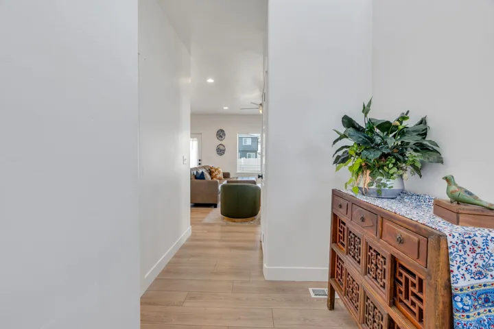 Recessed lighting illuminates the wood-finish flooring