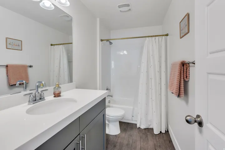 Vanity with an integrated sink, polished chrome faucet, and dark wood-finish cabinetry