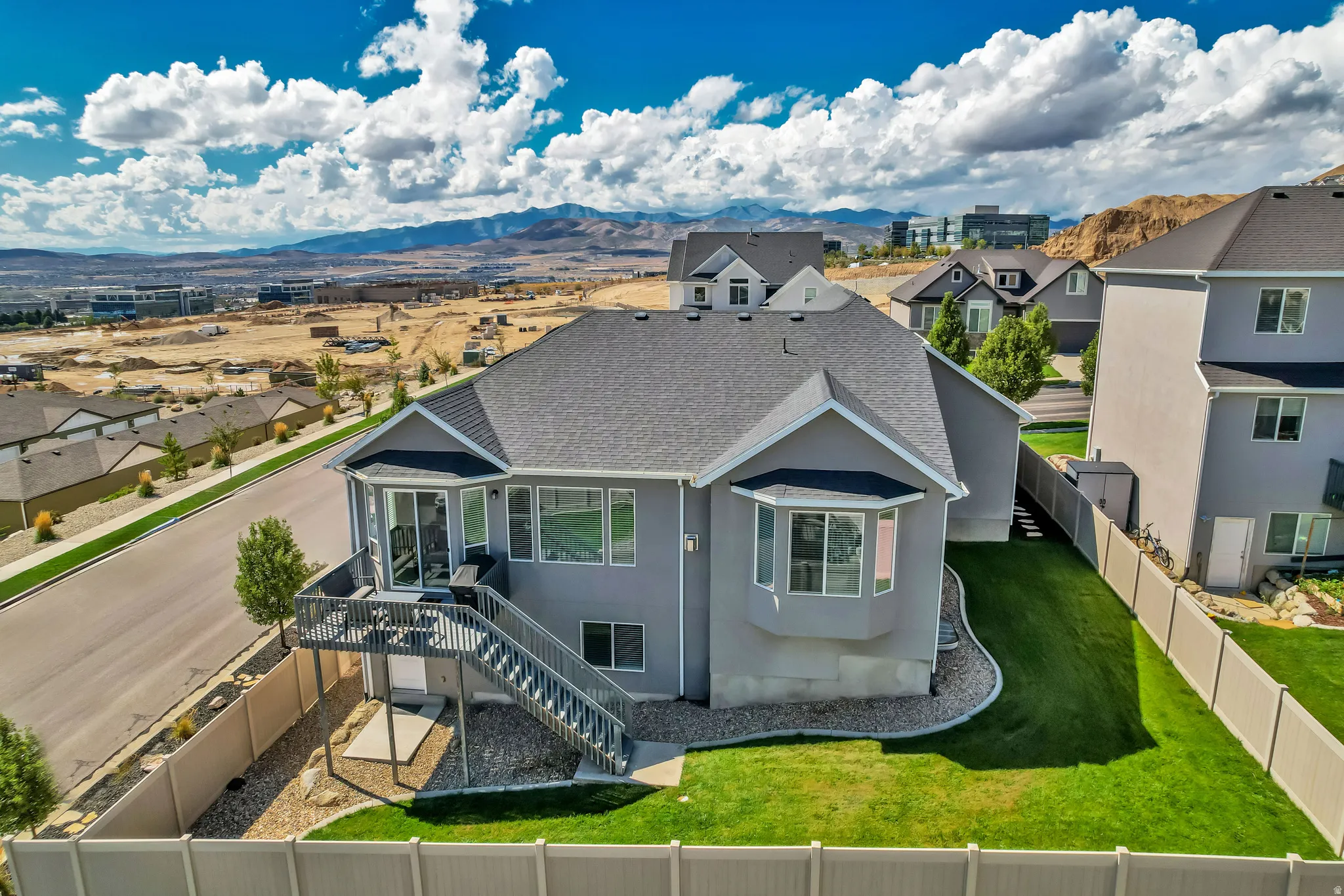 Contemporary gray exterior with a dark gray shingled roof
