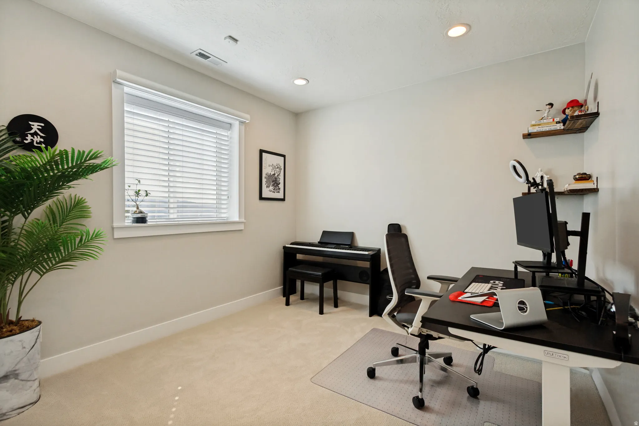 Neutral-toned walls complement the light-colored carpeting