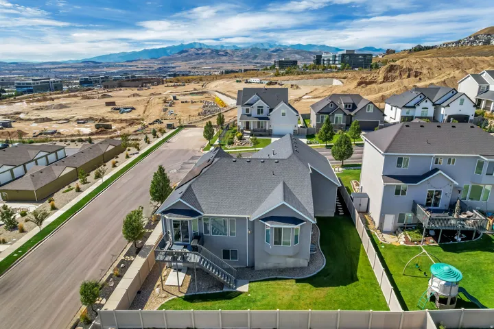 Property featuring a multi-level deck, bay windows, and a landscaped backyard