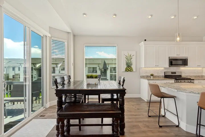 Kitchen with white cabinetry, stainless steel appliances, and a light-toned backsplash