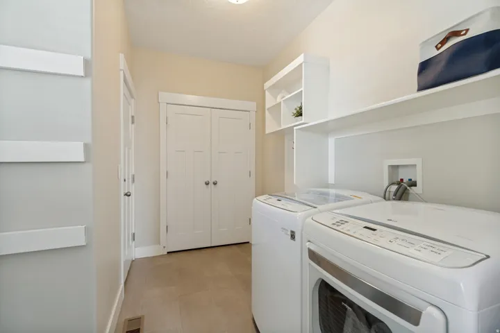 Built-in shelving, white bi-fold closet doors, tile flooring