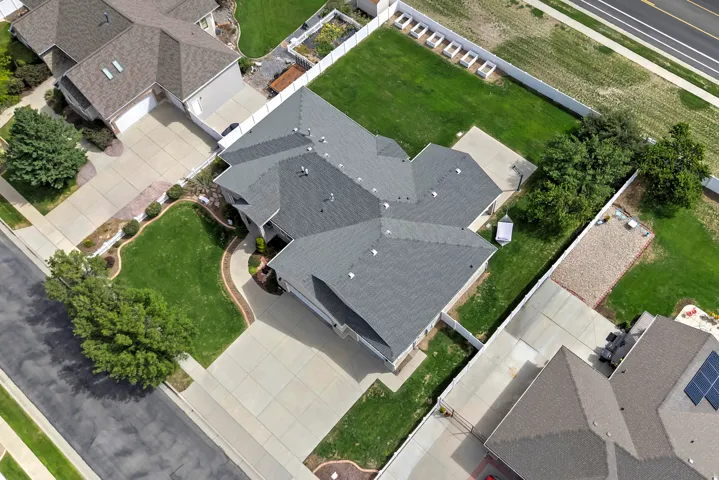 Gabled roofline, concrete driveway, concrete pathway, mature trees, manicured lawns