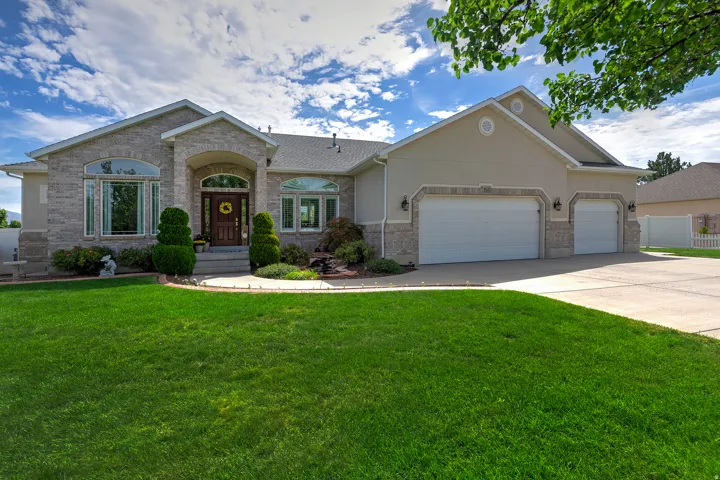 Stone and stucco exterior with an arched entryway