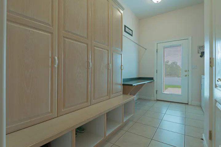 Built-in storage cabinetry with panel doors, open cubby shelving, and a dark countertop