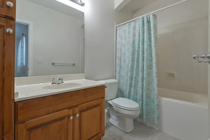 Wood-finish vanity with an integrated sink and light-toned countertop