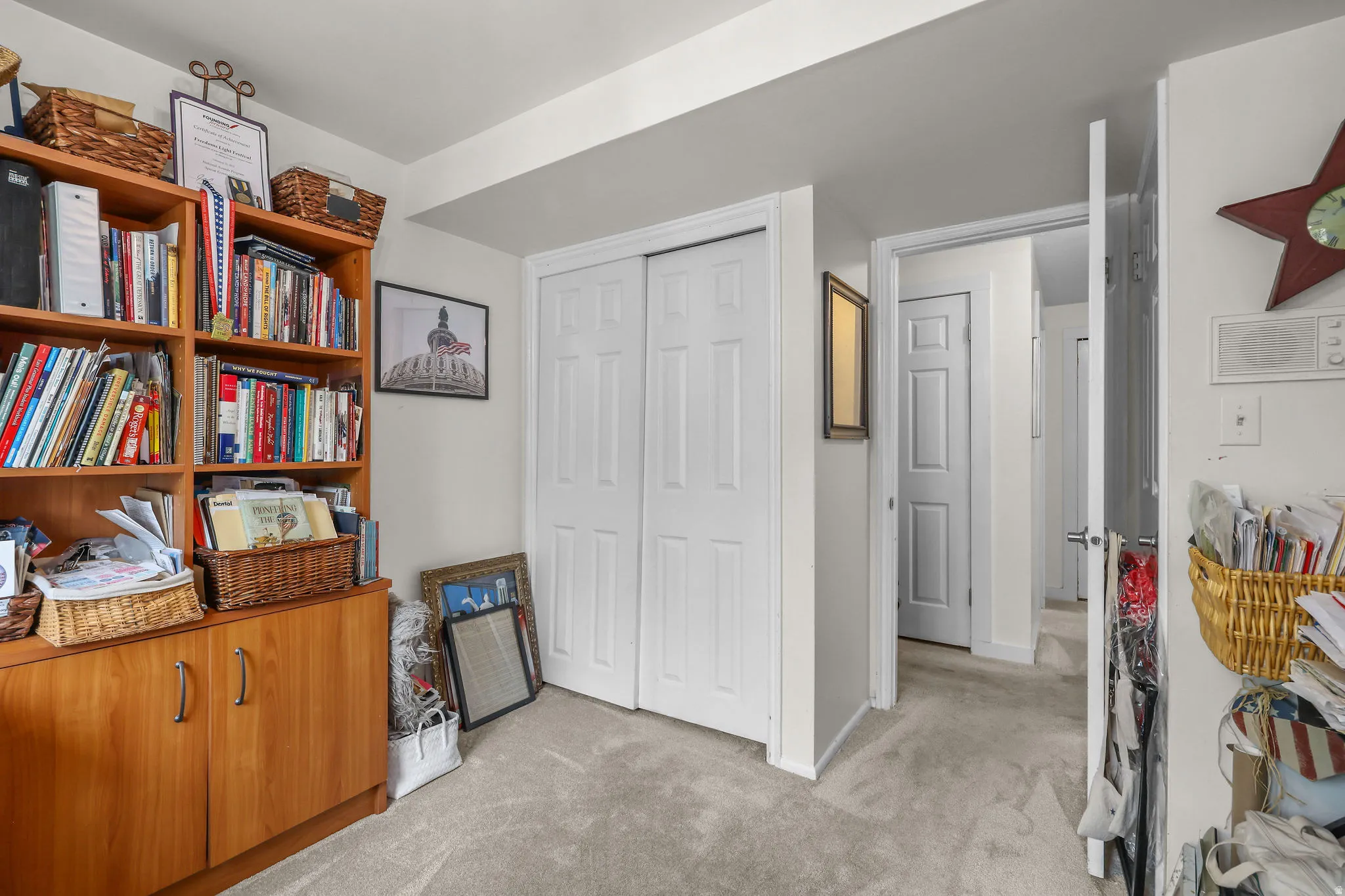 Neutral-toned wall-to-wall carpeting and white interior doors