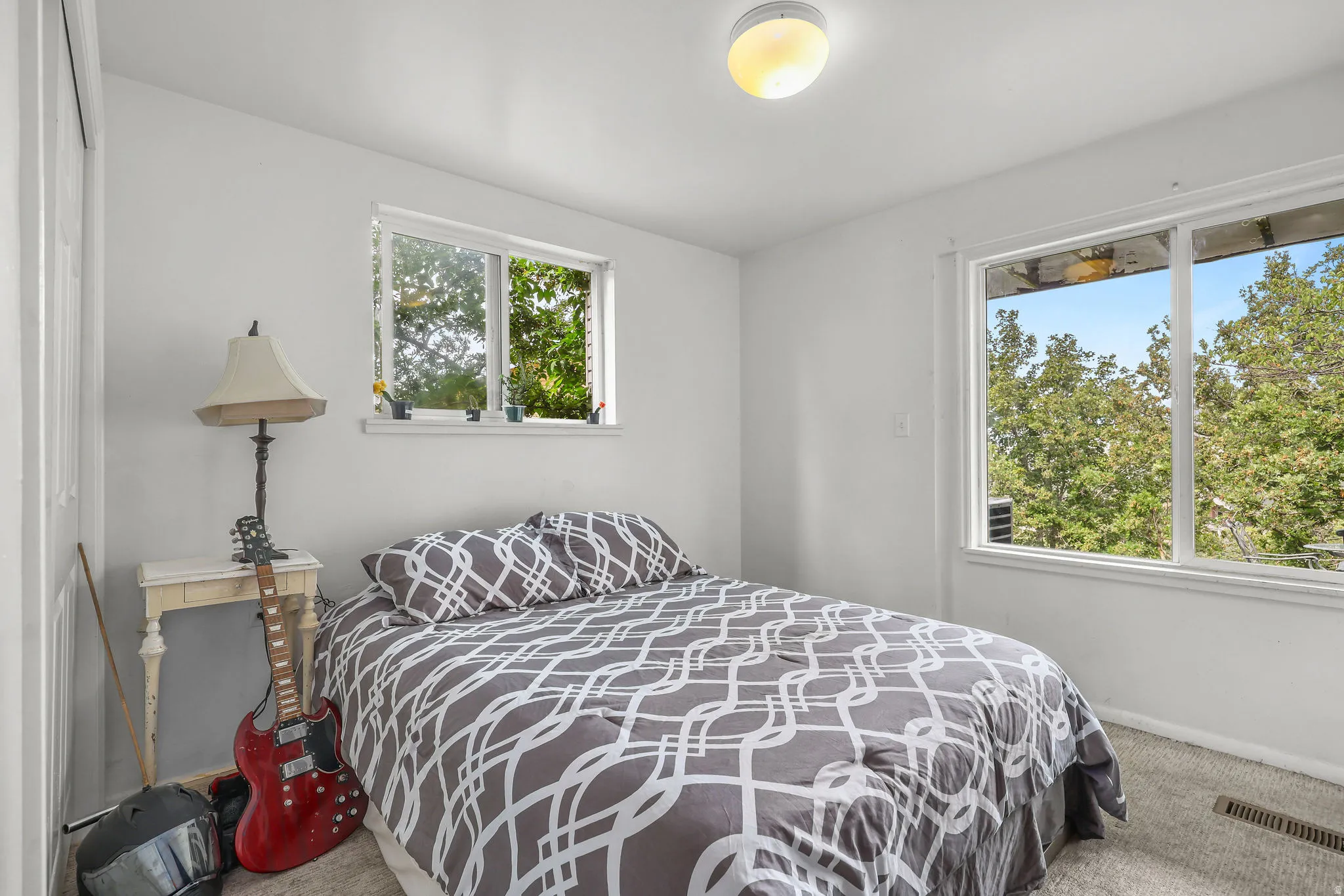 Recessed lighting, light-colored carpeting, two windows, and a built-in closet