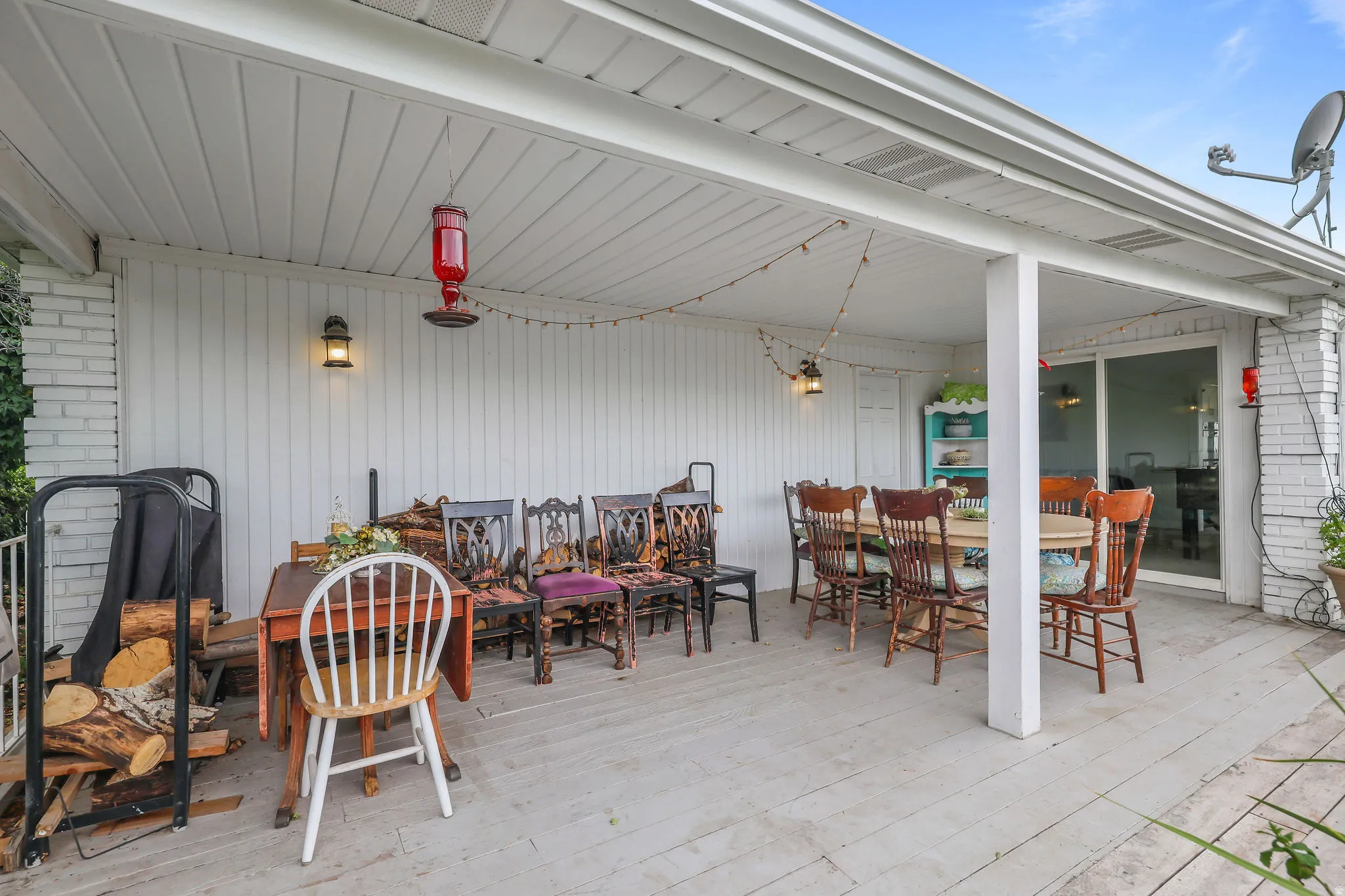 Covered patio featuring a solid roof, white siding, and a sliding glass door
