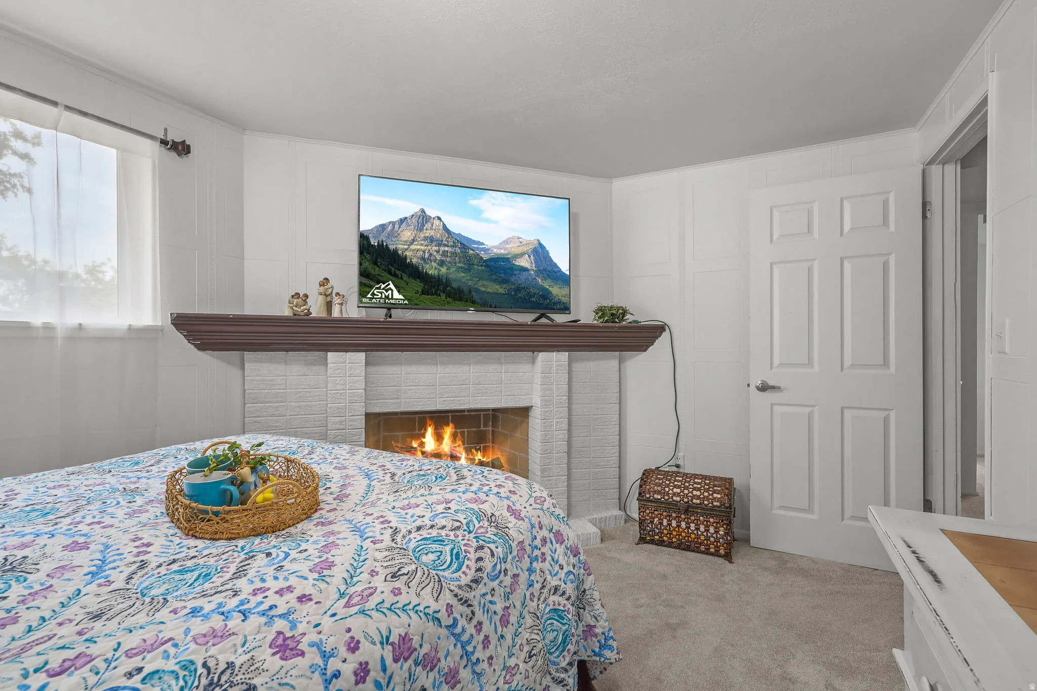 White brick fireplace with a wood mantel
