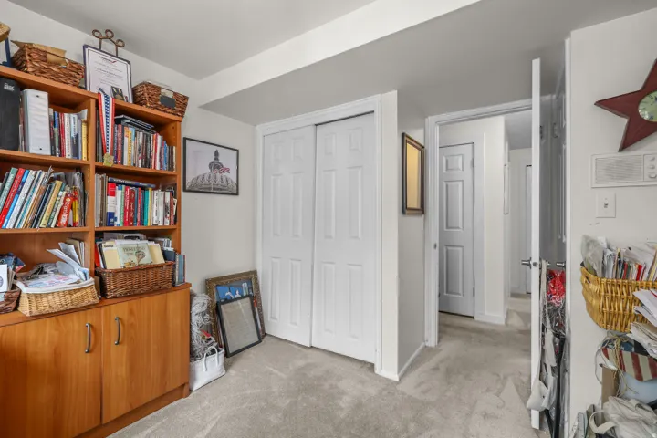 Neutral-toned wall-to-wall carpeting and white interior doors