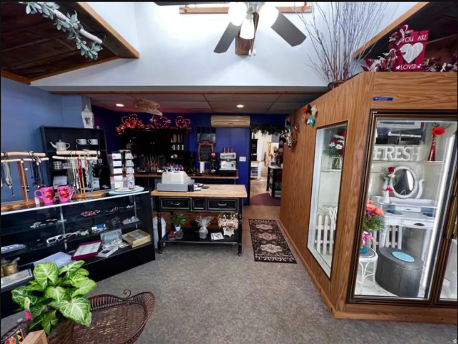 Wood-paneled walls and ceiling elements, recessed lighting, and a ceiling fan