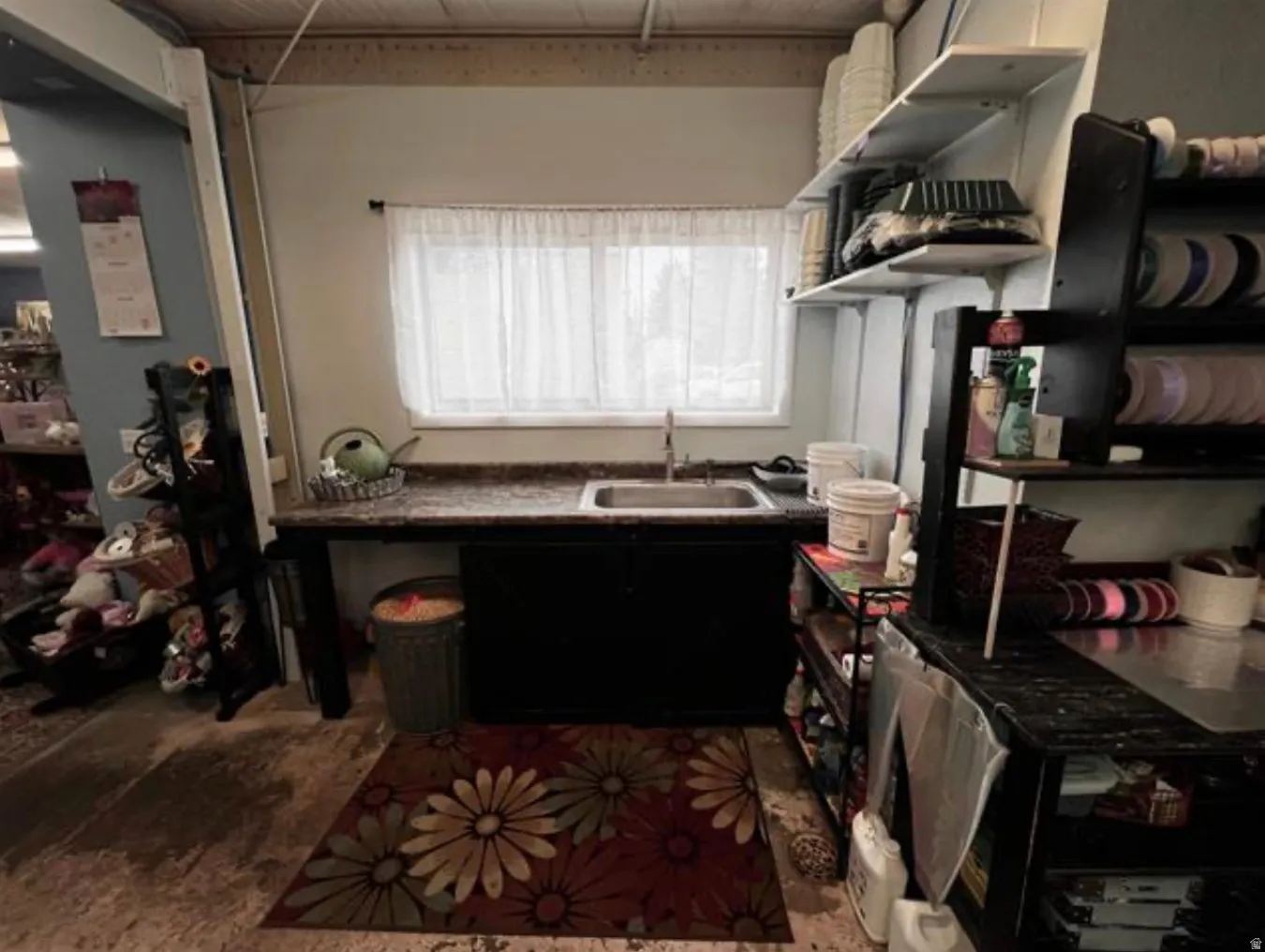 Built-in shelving, a single-basin sink, and ample counter space