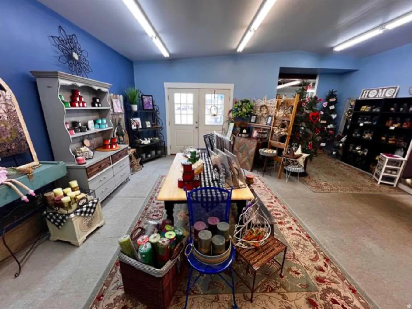 Painted interior walls, exposed ceiling ductwork, double-door entry, recessed lighting fixtures, and concrete flooring