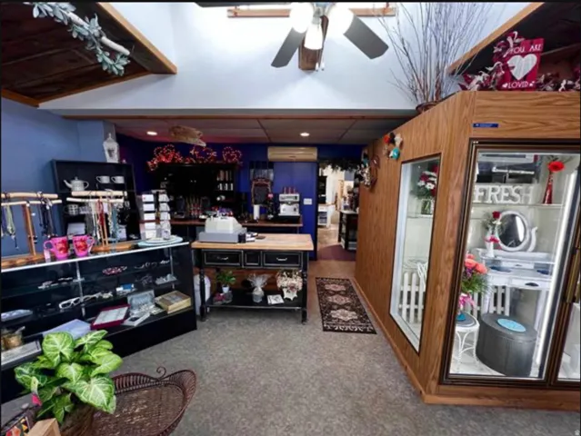 Wood-paneled walls and ceiling elements, recessed lighting, and a ceiling fan