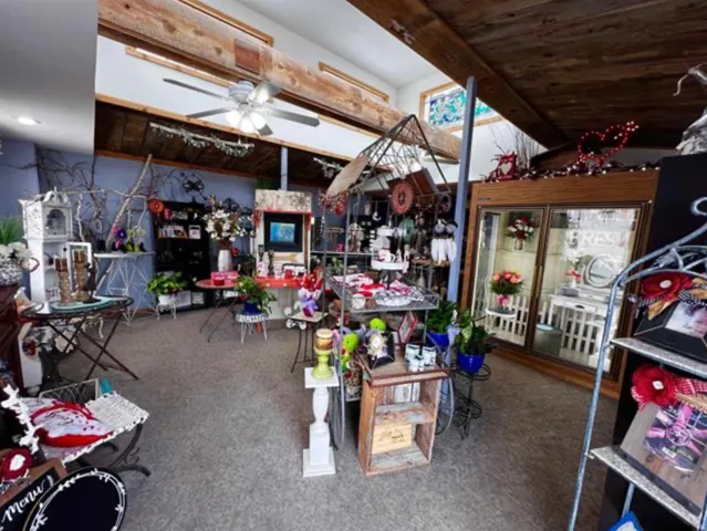 Exposed wood beams, ceiling fan light fixture, recessed lighting, and wall-mounted shelving