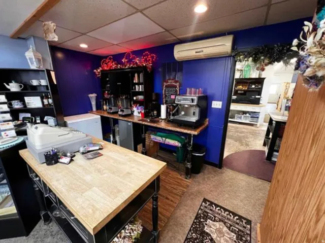 Built-in shelving, wood-finish countertop, recessed lighting, and wall-mounted air conditioning unit