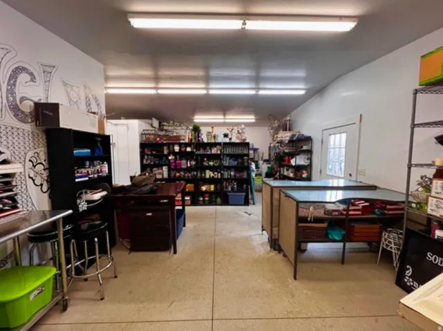 Spacious interior with concrete flooring and overhead fluorescent lighting