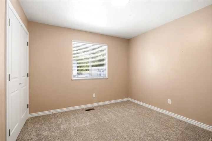 Neutral-toned walls complement plush carpeting