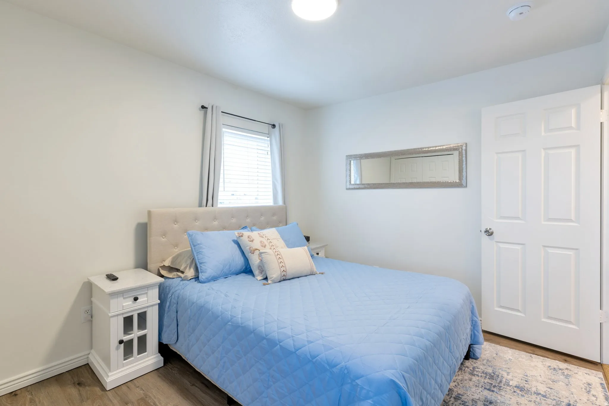 Recessed lighting, wood-finish flooring, and window with blinds