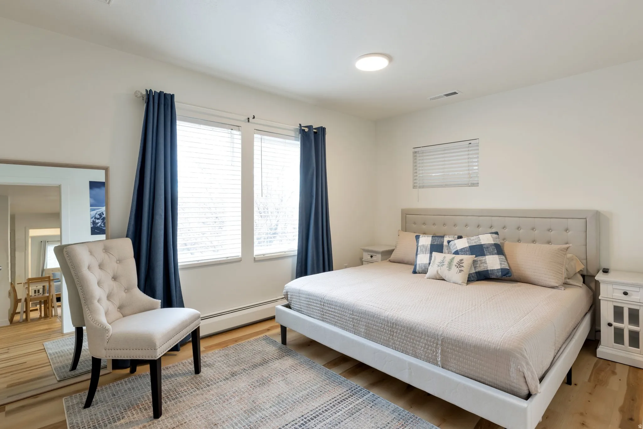 Warm wood-finish flooring with white walls