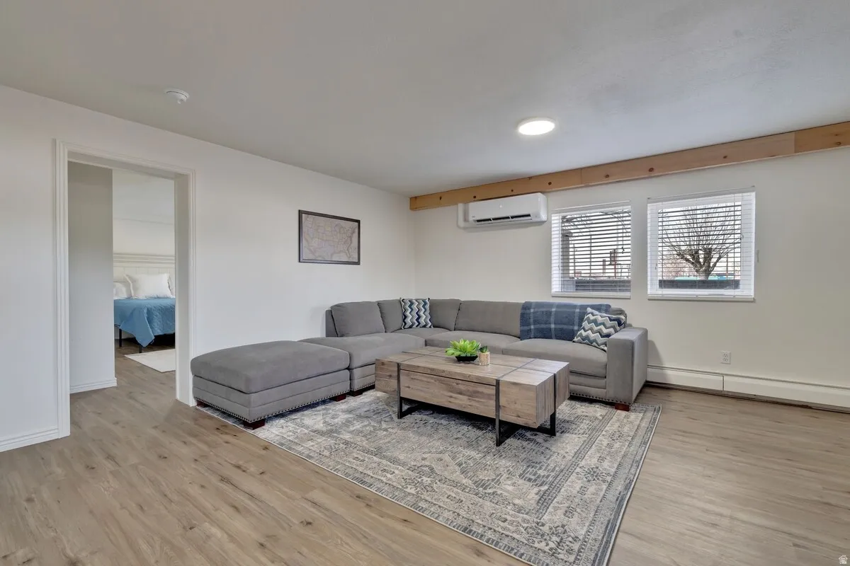 Wood-finish flooring, recessed lighting, and white walls