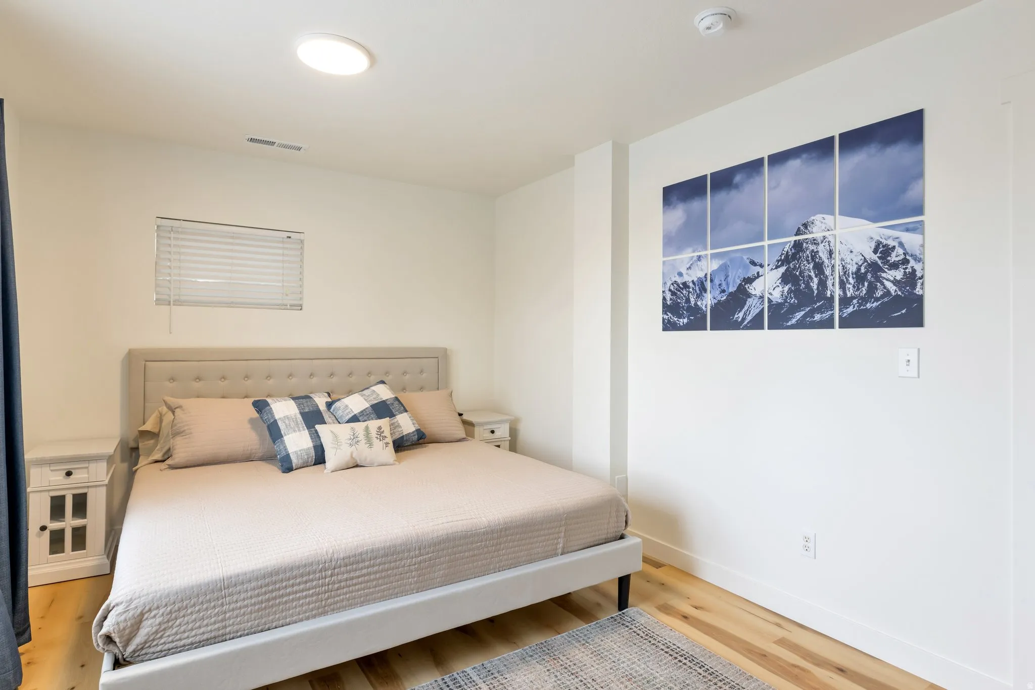 Recessed lighting, wood-finish flooring, and white walls