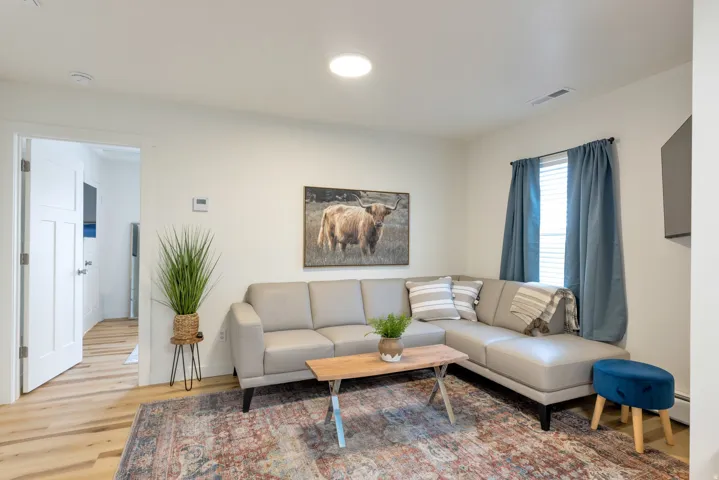 Light wood-finish flooring with white baseboards throughout
