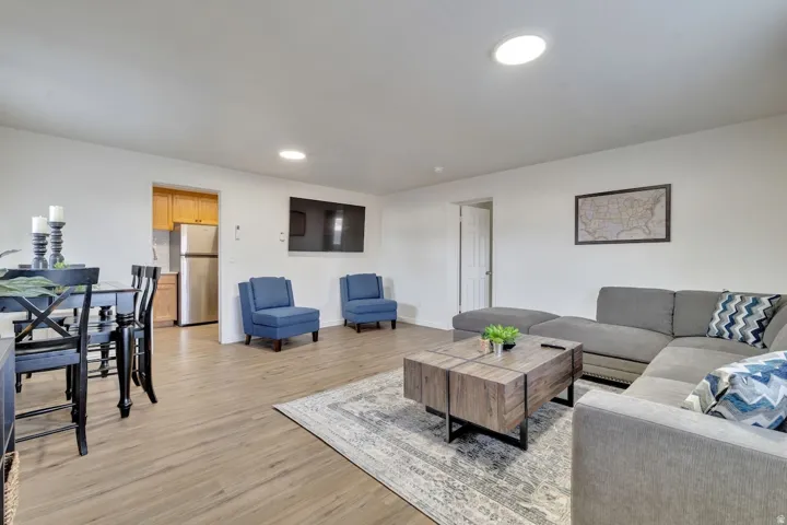 Wood-finish flooring throughout, recessed ceiling lighting, and an open concept layout