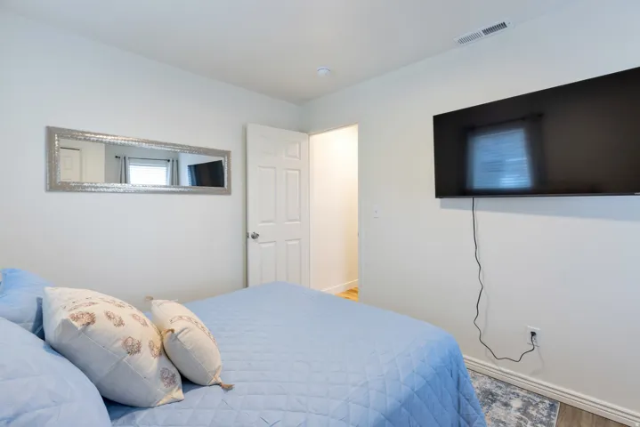 White painted walls with wood-finish flooring