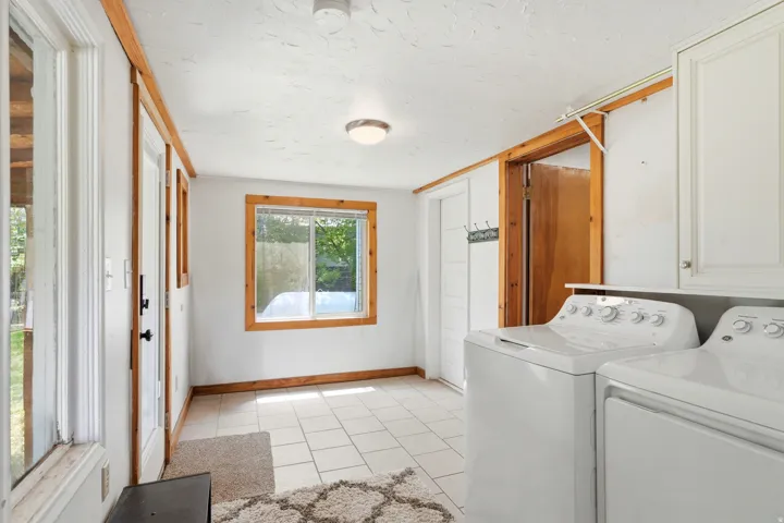White tiled flooring, white walls, and wood trim detailing