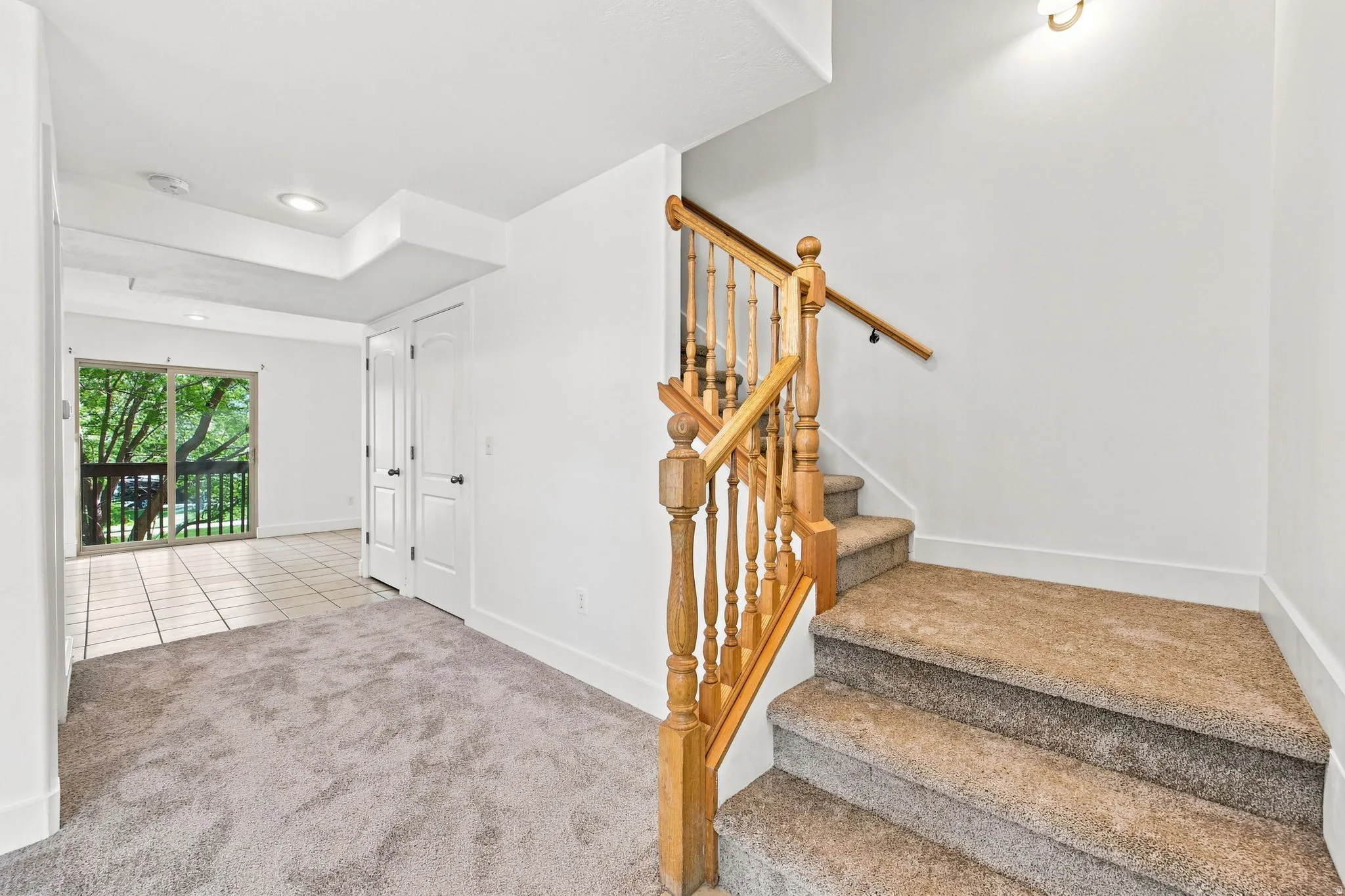 Carpeted stairs with wood-finish balustrade and handrail
