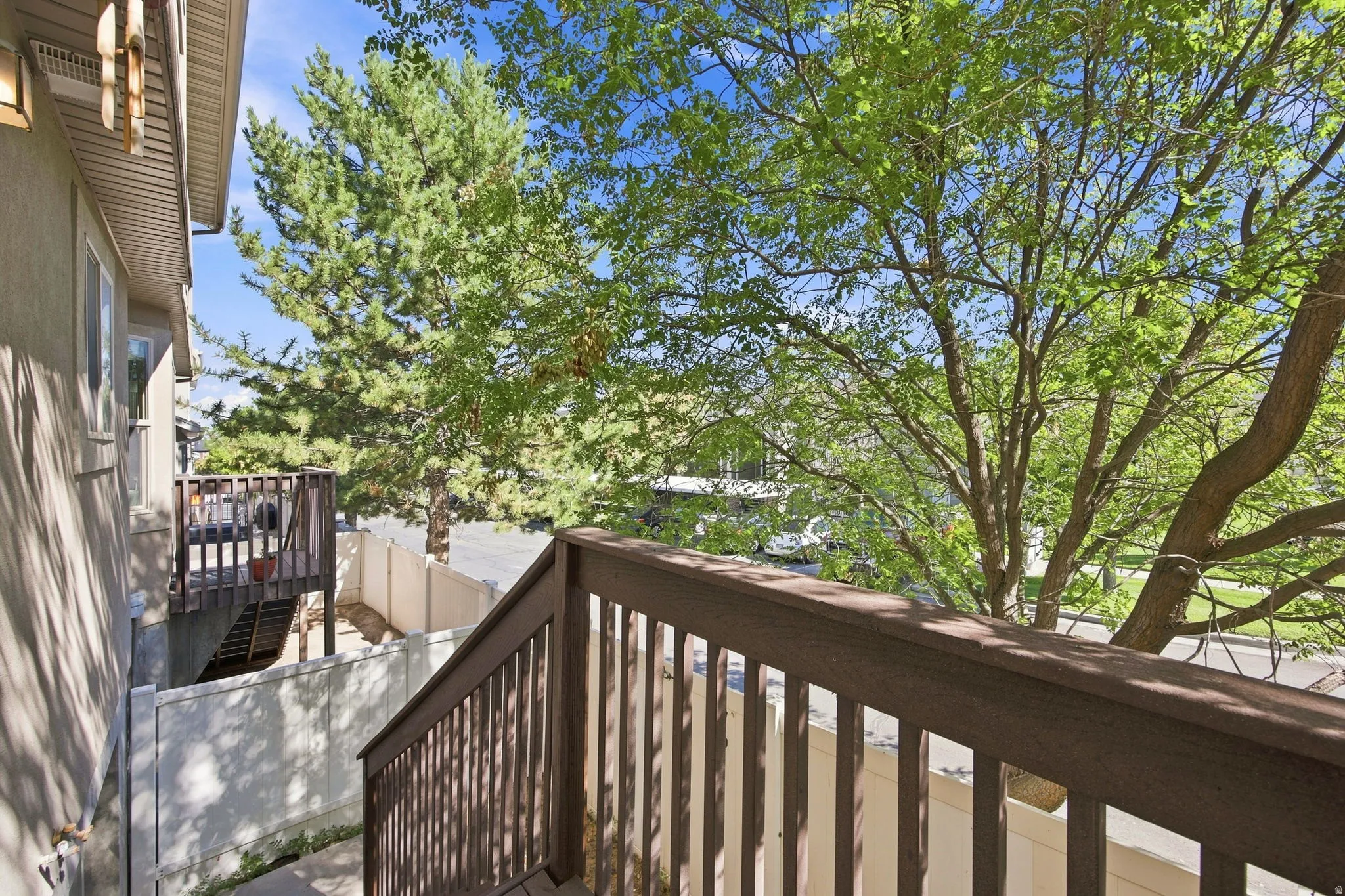 Exterior deck with dark wood-finish railing and steps