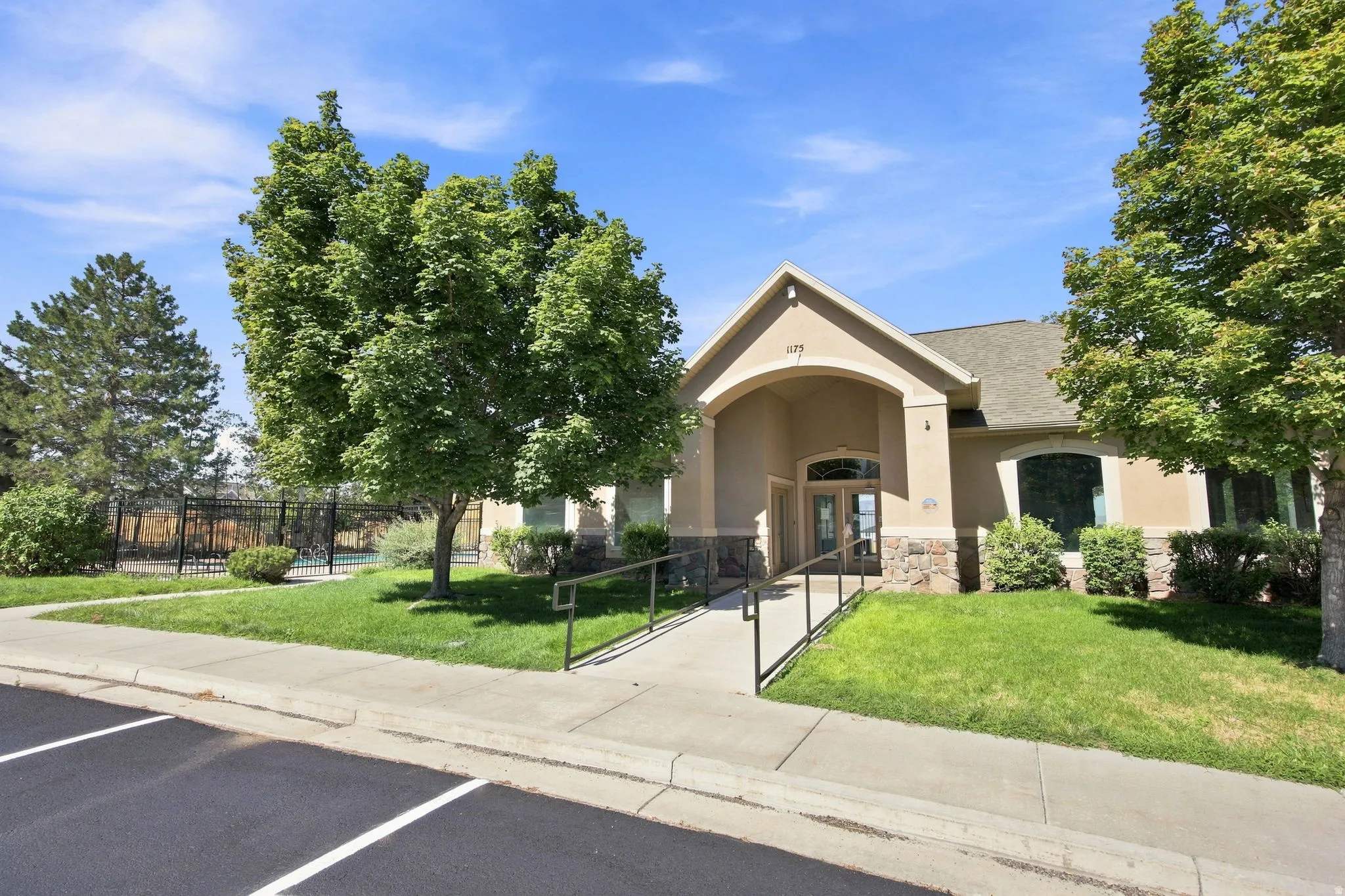 Stucco exterior with stone accents and an arched entry