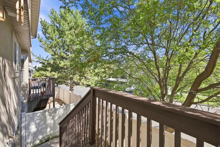 Exterior deck with dark wood-finish railing and steps