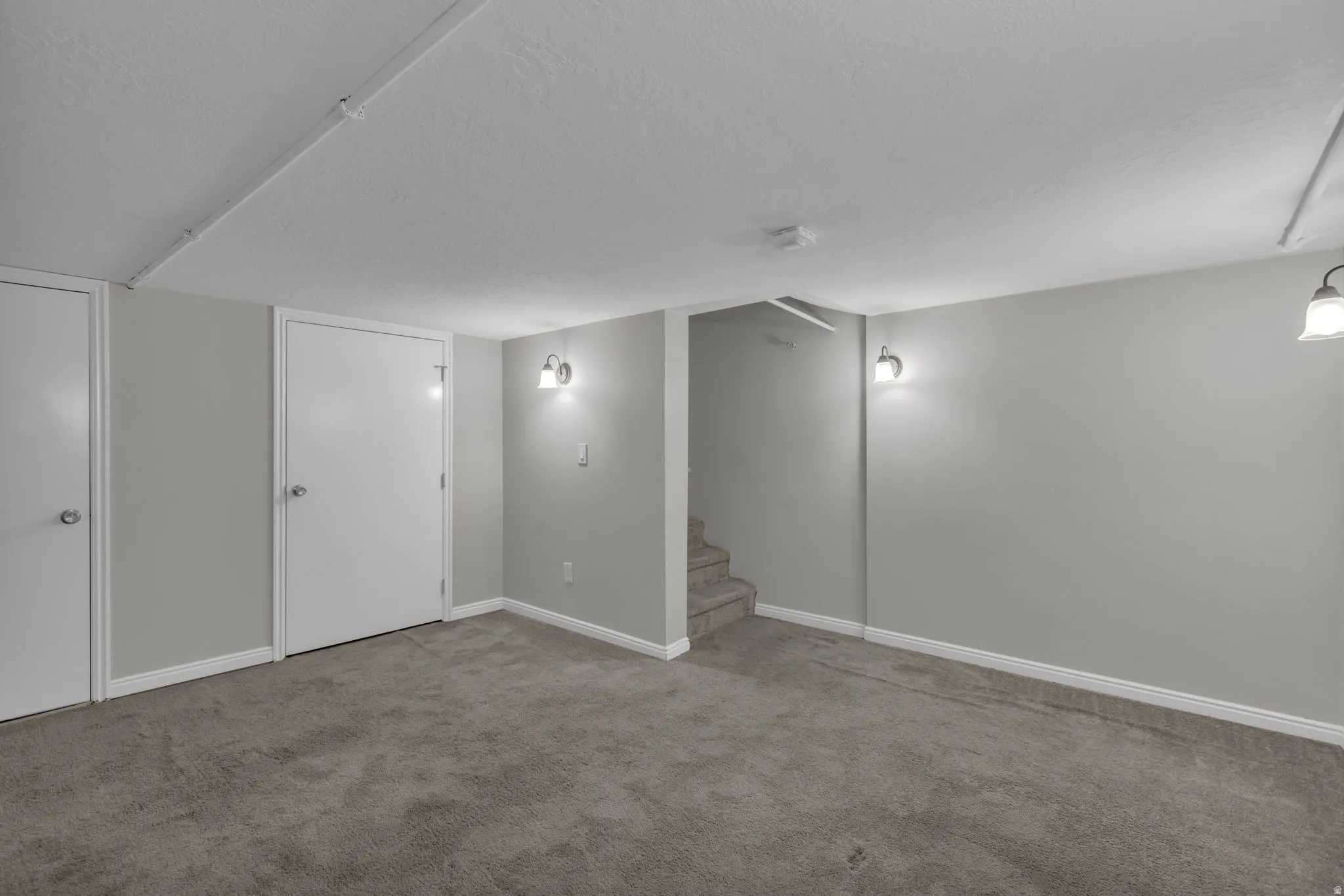 Recessed lighting track and sconce lighting fixtures provide illumination