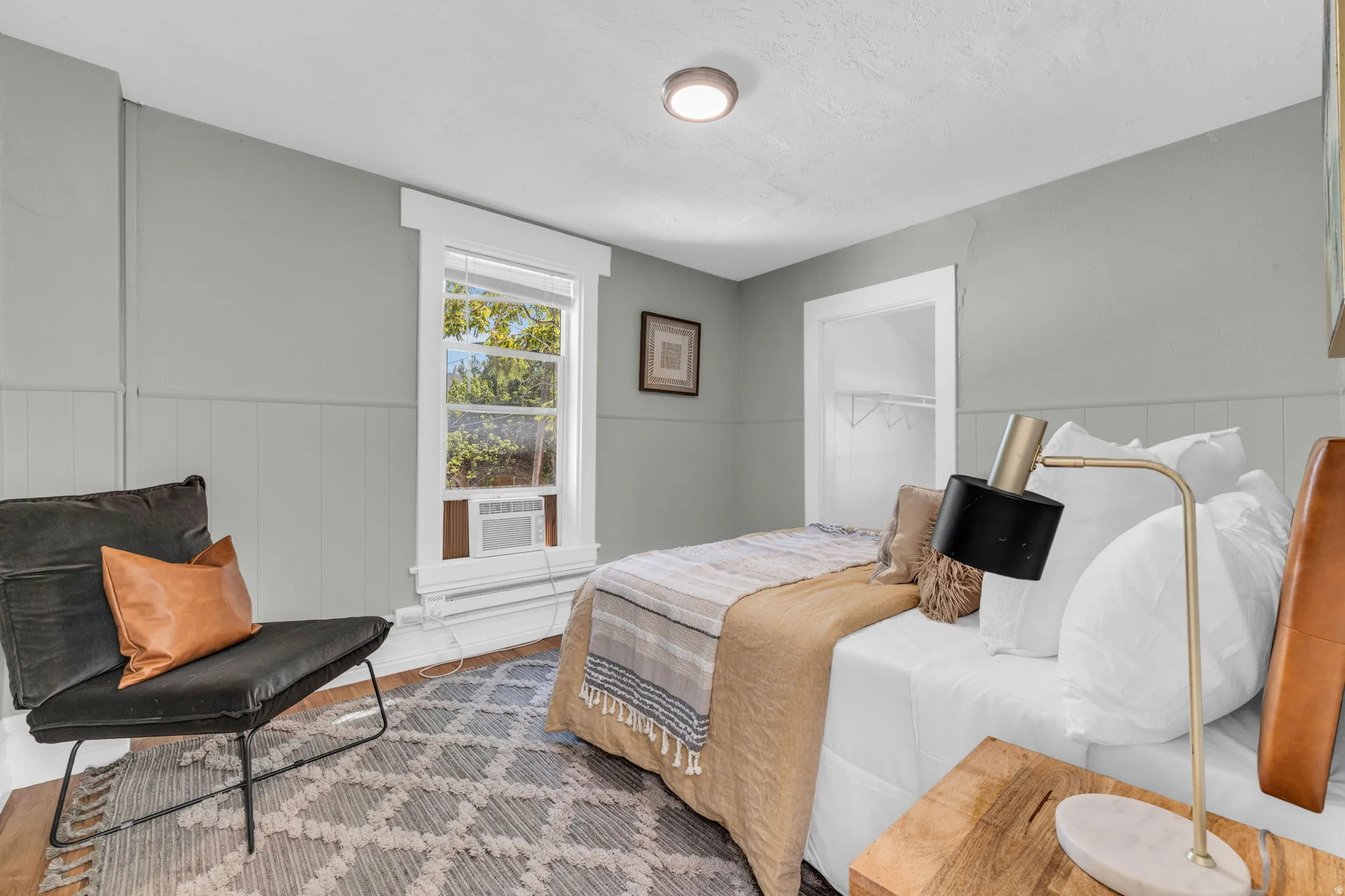Painted paneling with a window and a recessed closet opening